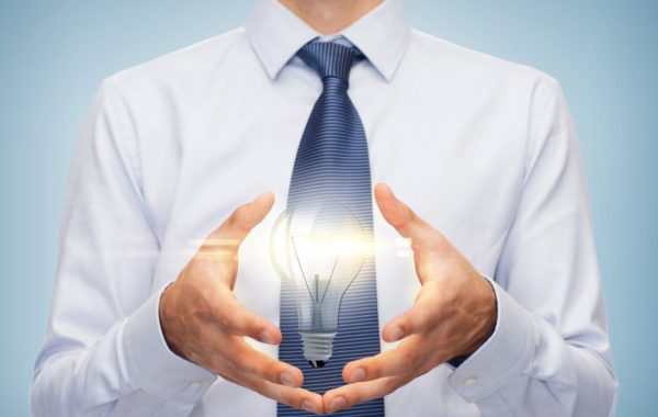 buisnessman holding something in his hands business and office, advertising, people concept - friendly young buisnessman holding something in his hand