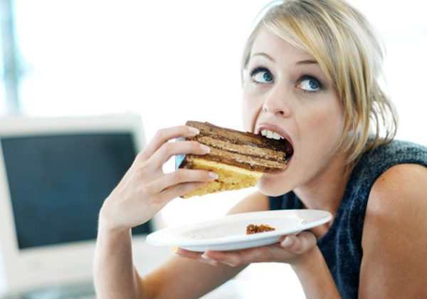 close-up of a woman eating a large piece of cake close-up of a woman eating a large piece of cake