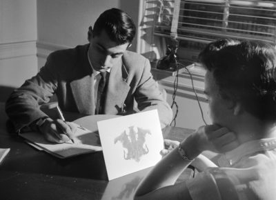 circa 1950:  A doctor at the Headache Clinic in the Montefiore Hospital using the Rorschach personality test to determine whether the patient's headaches have a psychological origin.  (Photo by Orlando /Three Lions/Getty Images)
