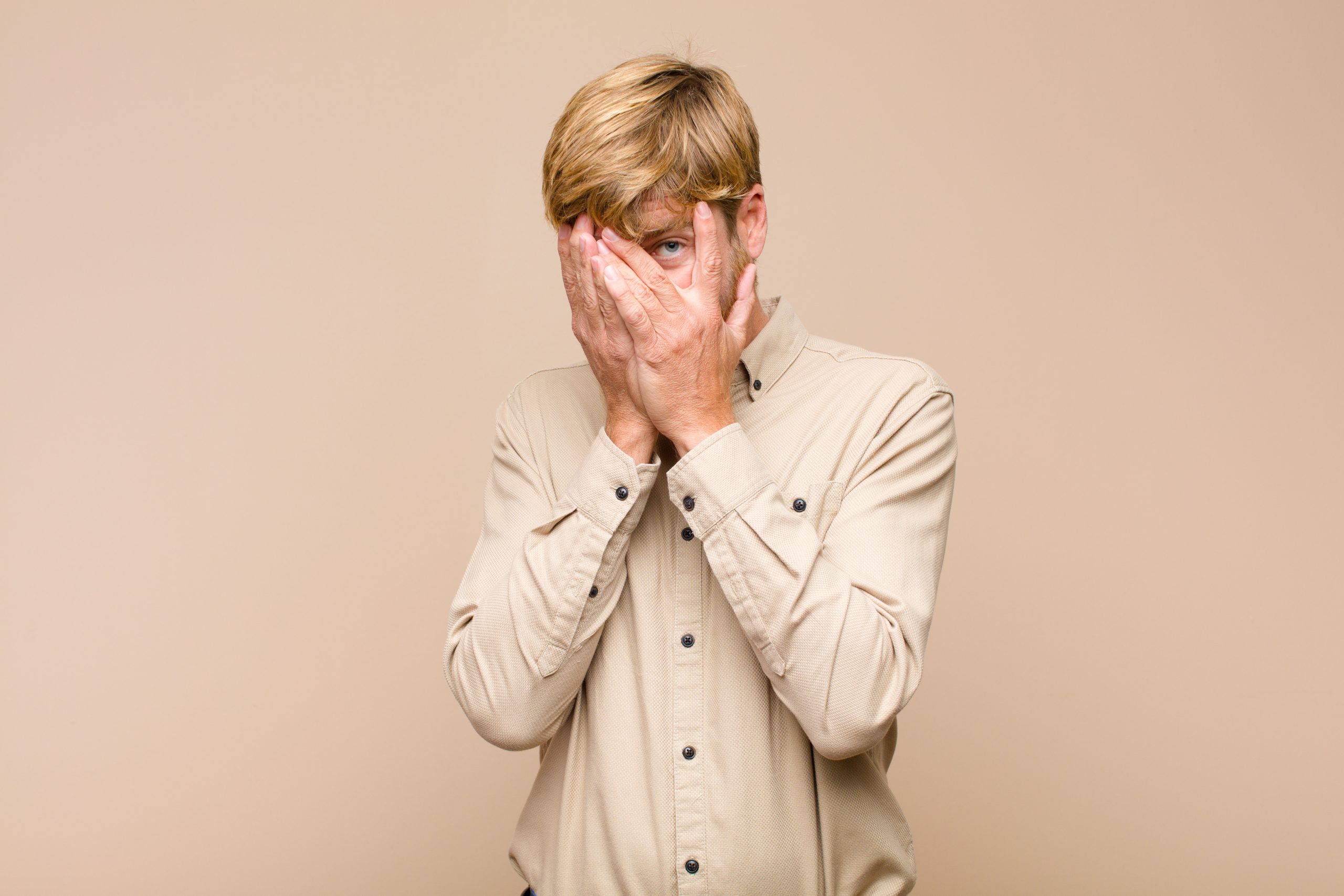 feeling scared or embarrassed, peeking or spying with eyes half-covered with hands