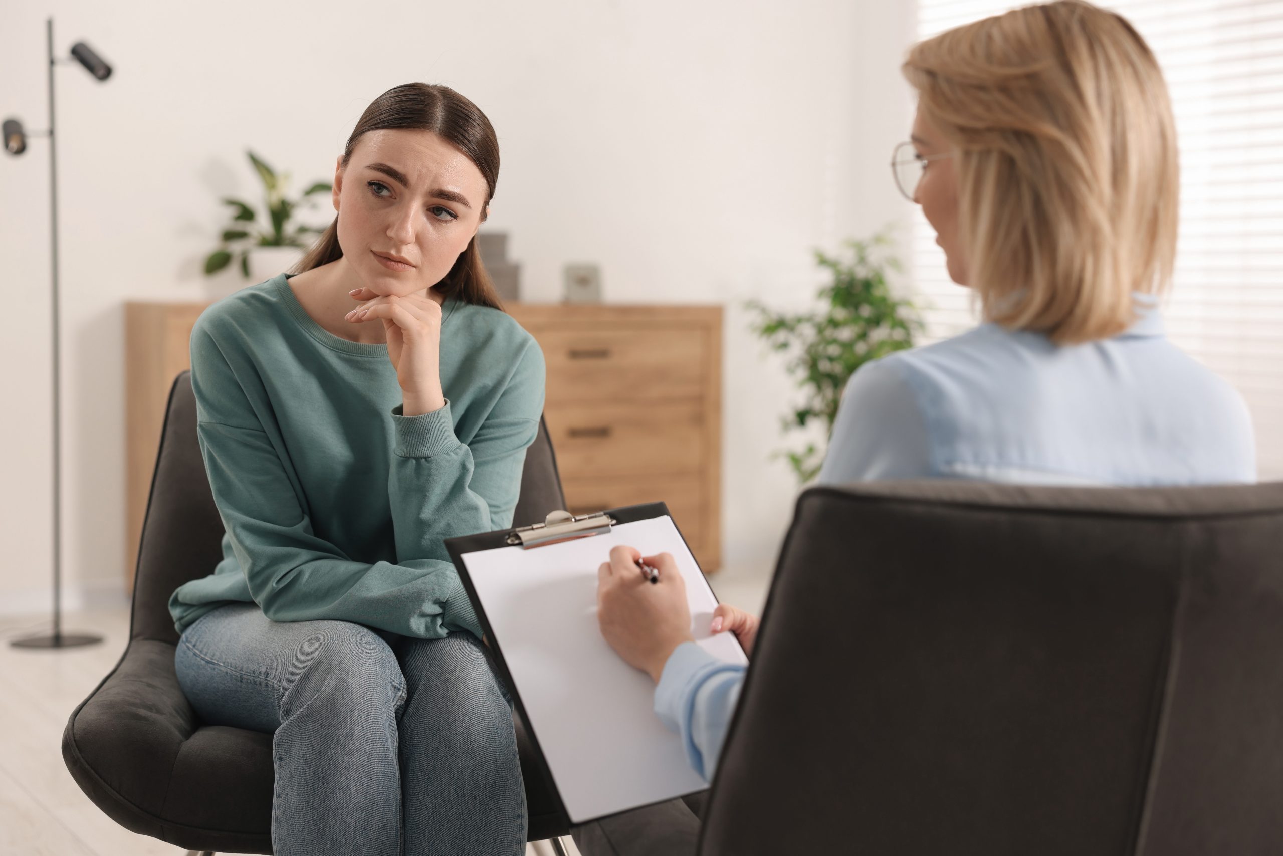 Professional psychotherapist working with patient in office