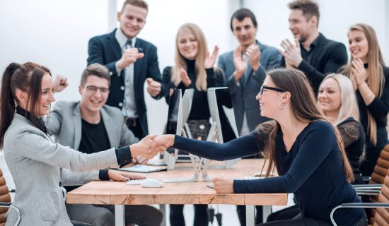 two smiling business woman shaking hands with each other two smiling business woman shaking hands with each other. concept of partnership